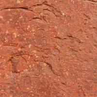 Red rough stone texture background. photo