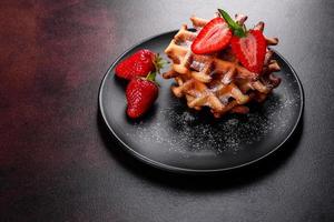 Delicious fresh baked belgian waffles with berries and fruit photo