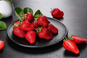 Beautiful juicy fresh strawberries on the concrete surface