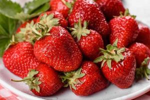 Beautiful juicy fresh strawberries on the concrete surface photo