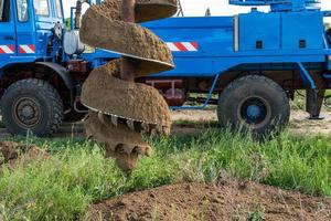 Tracer tractor with auger for soil drilling for piles photo