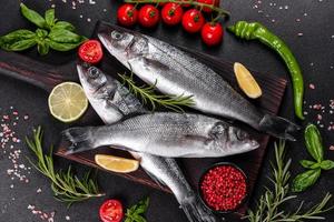 Fresh fish seabass and ingredients for cooking. Raw fish seabass photo