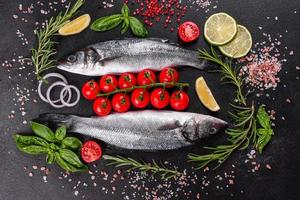 Fresh fish seabass and ingredients for cooking. Raw fish seabass photo