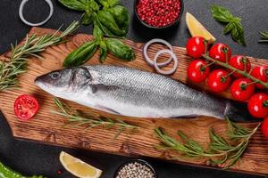 Fresh fish seabass and ingredients for cooking. Raw fish seabass photo