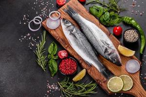 Fresh fish seabass and ingredients for cooking. Raw fish seabass photo