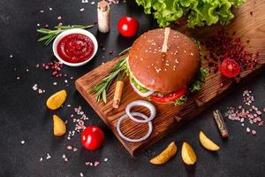Delicious fresh homemade burger on a wooden table photo
