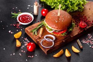 Delicious fresh homemade burger on a wooden table photo