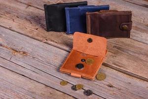 Hand made leather man wallet on wooden background photo