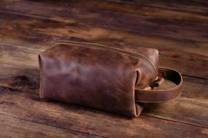 Beautiful small women's leather bag on a wooden background photo