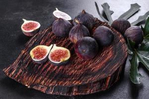 Fresh ripe figs on a dark concrete background. Harvesting figs photo