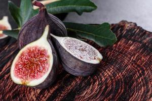 Fresh ripe figs on a dark concrete background. Harvesting figs photo