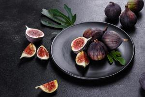 Fresh ripe figs on a dark concrete background. Harvesting figs photo