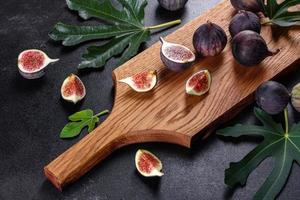 Fresh ripe figs on a dark concrete background. Harvesting figs photo