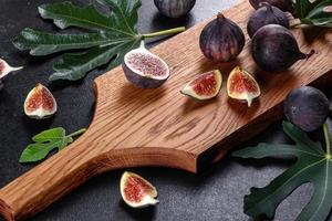 Fresh ripe figs on a dark concrete background. Harvesting figs photo