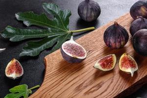 Fresh ripe figs on a dark concrete background. Harvesting figs photo