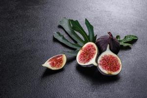 Fresh ripe figs on a dark concrete background. Harvesting figs photo