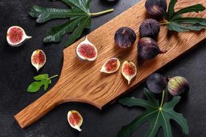 Fresh ripe figs on a dark concrete background. Harvesting figs photo