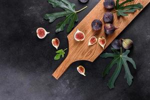 Fresh ripe figs on a dark concrete background. Harvesting figs photo