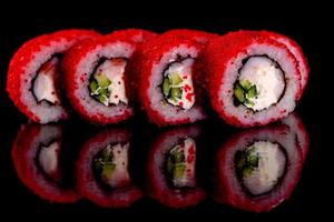 Fresh delicious beautiful sushi rolls on a dark background photo