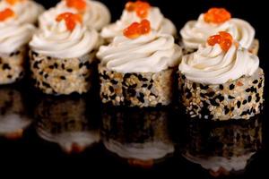 Fresh delicious beautiful sushi rolls on a dark background photo