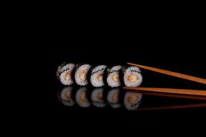 Fresh delicious beautiful sushi rolls on a dark background photo