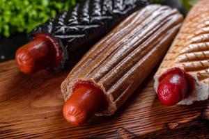 Delicious fresh hot hotdogs with various kinds of buns and sausages. photo