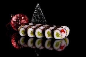 Fresh delicious beautiful sushi rolls on a dark background photo