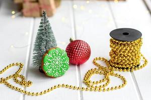 Beautiful multi-colored Christmas decorations on a light wooden table photo