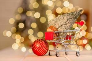 Shopping cart with Christmas gifts and presents. Christmas shopping photo