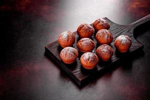 Beautiful delicious fresh cocoa muffins on the Christmas table photo