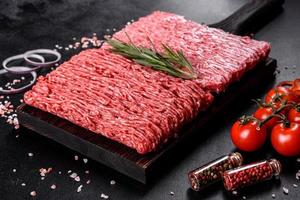 Fresh raw beef mince on a dark background photo