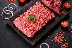 Fresh raw beef mince on a dark background photo