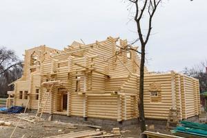 Construction of a Christian church made of wooden treated logs photo