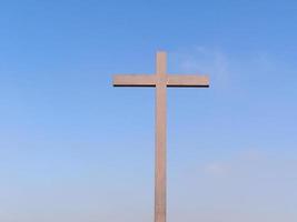 Wooden cross over blue sky photo