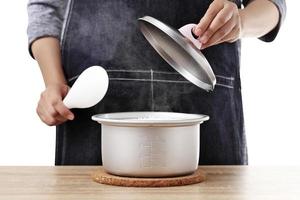 Woman open rice pot on white background photo