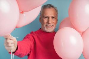 Smiling, cheerful man with balloons photo