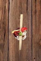 Cheese appetizer in a wine glass and chopsticks photo