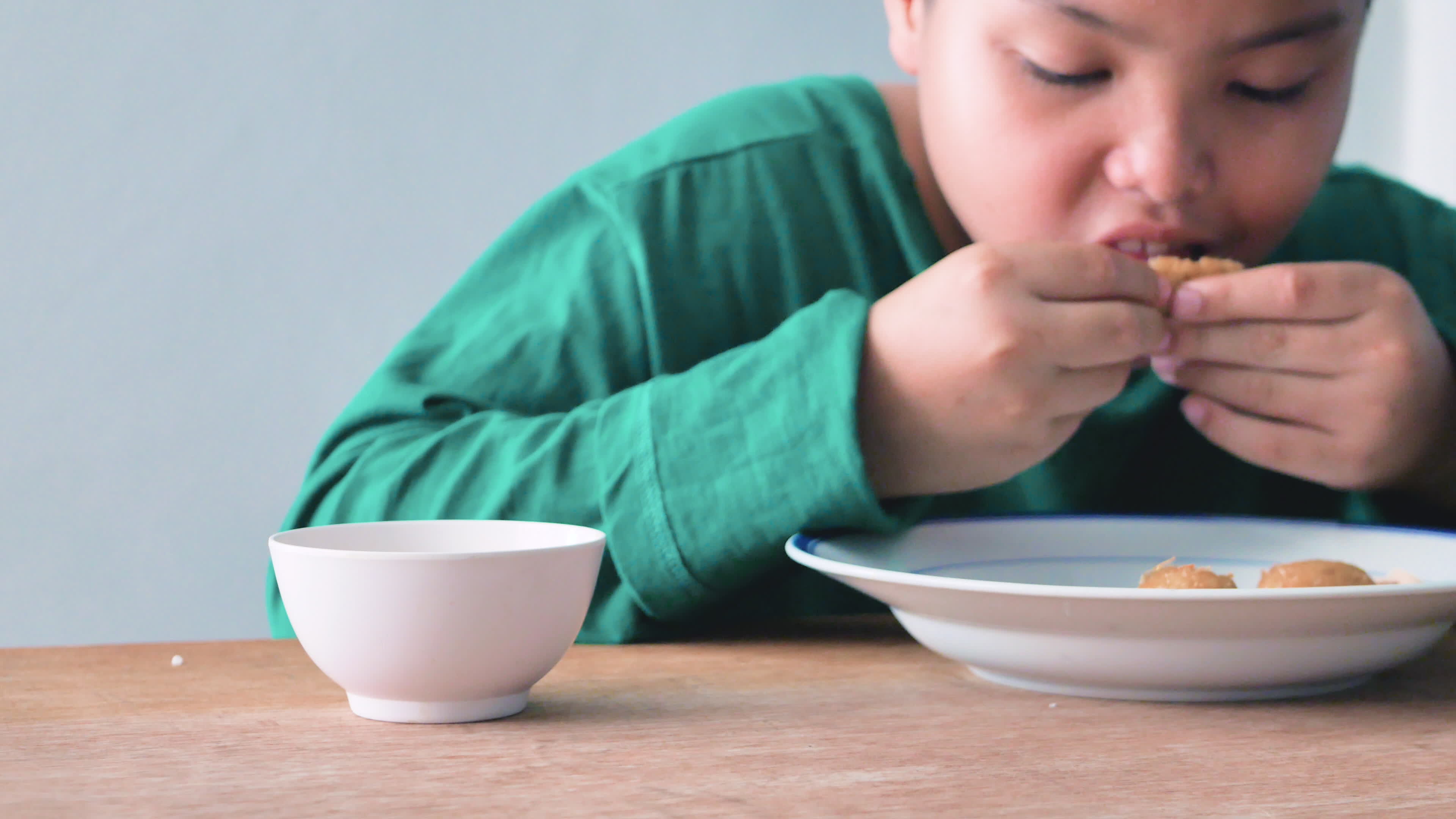 A Child Boy Is Having Lunch On The Table Front View Close Up Shot a-child-boy-is-having-lunch-on-the-table-front-view-close-up-shot