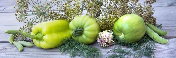 Tomatoes and a bunch of dill lie on background photo