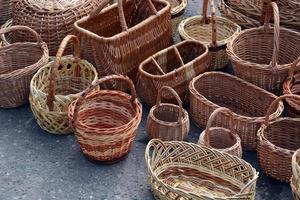 Wicker baskets of various shapes and sizes. Handmade on the market. photo