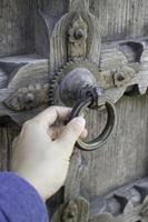 Old open wooden door with carved pattern photo