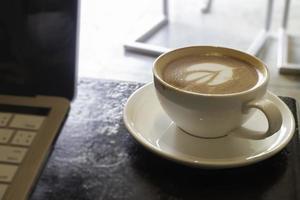 Latte art on hot milk coffee photo