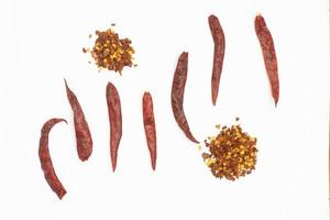 Dried red pepper flakes isolated on white, top view photo