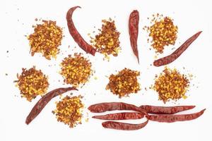 Dried red pepper flakes isolated on white, top view photo