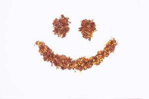 Dried red pepper flakes isolated on white, top view photo