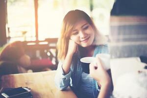 Two friends enjoying working together with in a coffee shop. photo