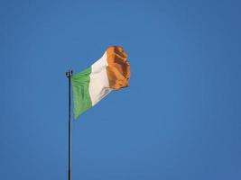 Irish Flag of Ireland over blue sky photo
