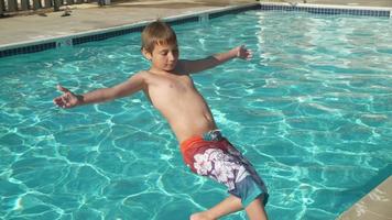 menino jogando água na piscina em câmera lenta, baleado no phantom flex 4k video