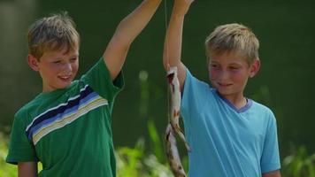 Boys holding up fish video