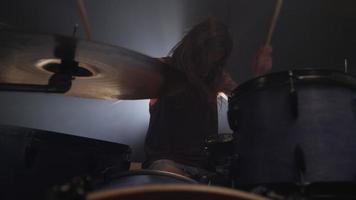 Man playing drums in heavy metal rock band, slow motion video